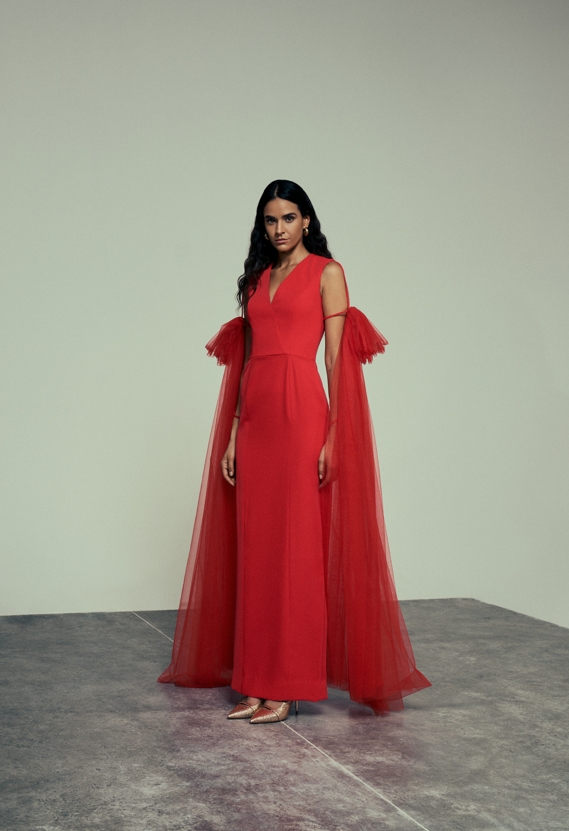 Red crepe gown with tulle drape